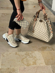 Sneakers set with LV lettering next to the shoes